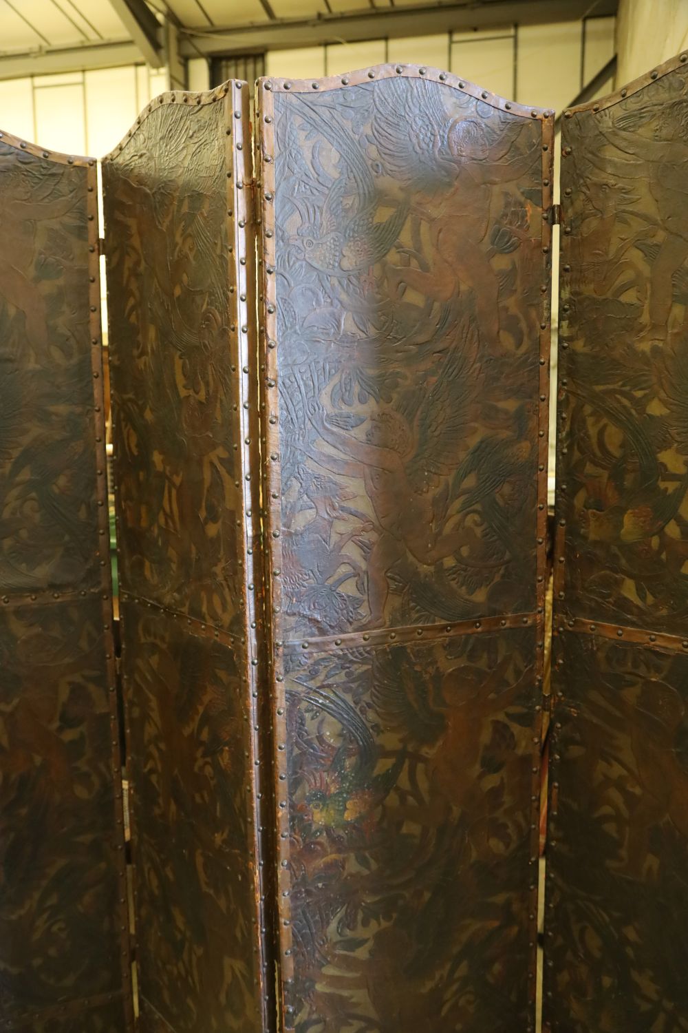 A Dutch leather four fold screen, c.1860, each panel 49cm x 203cm
